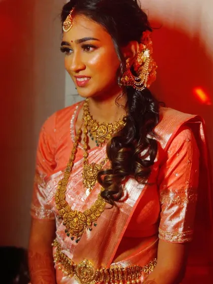 Ankita's reception look in a beautiful peach silk saree, with a messy braid and glowing makeup.