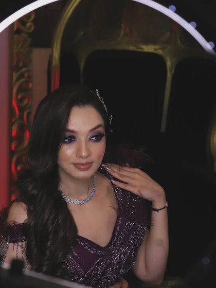 A creative portrait using a ring light to frame the subject. This technique adds a modern and stylish element, perfect for capturing a glamorous look at a cocktail party or reception.