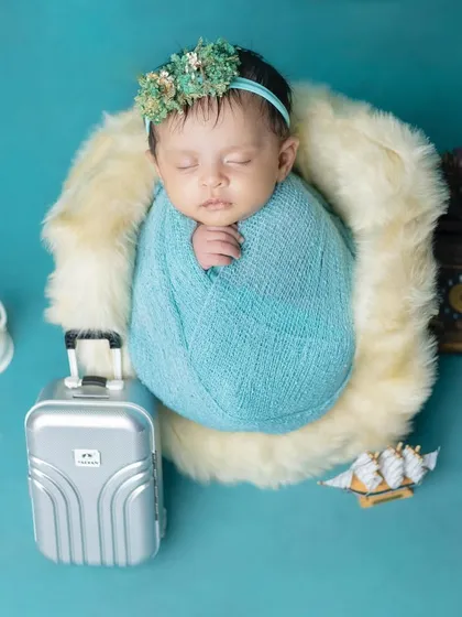 Ready for an adventure! This creative setup includes a tiny suitcase for a traveling baby.