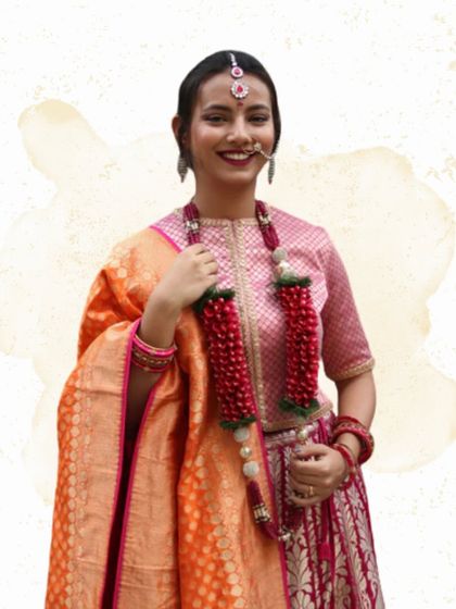 A model showcases one of my handcrafted fabric varmalas. The deep red color and intricate beadwork make it a stunning accessory that complements the bride's attire while being a lightweight and lasting keepsake.