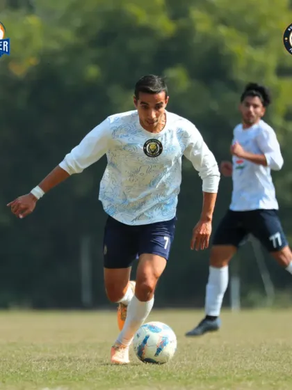 A player dribbles forward, focused on creating an opportunity for the team.
