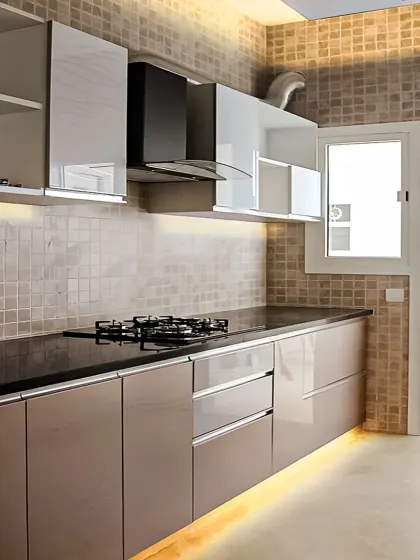 This kitchen showcases a two-tone design with glossy taupe lower cabinets and white upper cabinets. We added under-cabinet lighting to illuminate the countertop and a sleek chimney for ventilation.