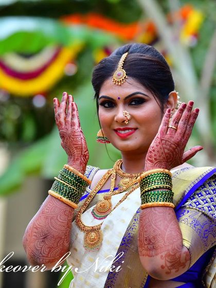 My beautiful bride Namrata, glowing for her wedding. Her look features bold, defined eyes and a bright smile, perfect for her white and blue silk saree.