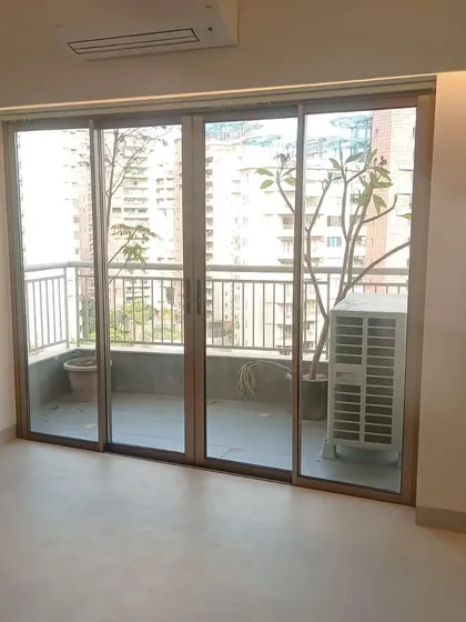 A four-panel sliding door installation, which opens up the living room to a large balcony.