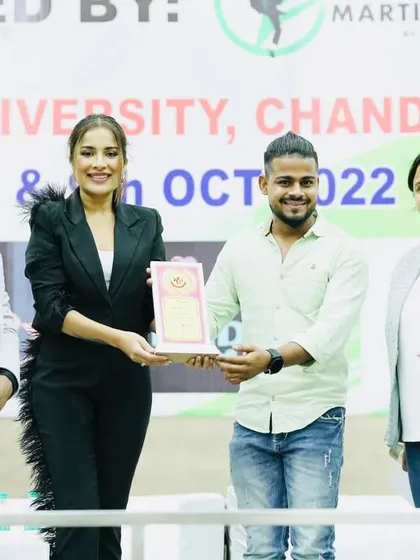 Receiving a team winner trophy from Punjabi singer Sara Gurpal at the GTA Cup. A proud moment for the academy.