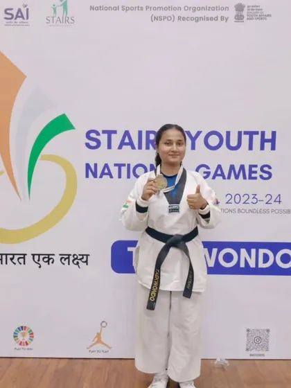 A black belt student showing her gold medal from the Stairs Youth National Games. We guide our athletes through every stage, from local tournaments to national platforms.