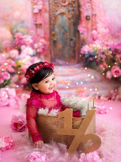 Halfway to one! This six-month milestone session is marked with a beautiful wooden sign, celebrating this adorable baby girl's half-birthday in a magical butterfly garden.