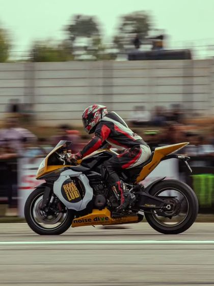 Another shot of the yellow and black superbike, showcasing its unique design and the rider's focused posture.