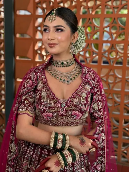 A classic bridal look is all about timeless elegance. Here, I created a soft, dewy makeup look with a focus on enhancing her natural features. The subtle smokey eye, paired with a neutral lip and a traditional gajra bun, completes this stunning bridal transformation, perfect for the main wedding ceremony.