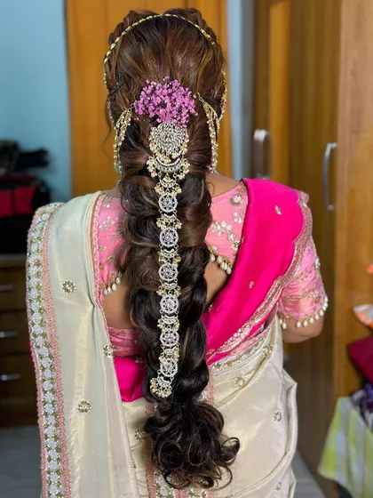 An intricate and heavily embellished braid, a stunning choice for a grand pre-wedding celebration.