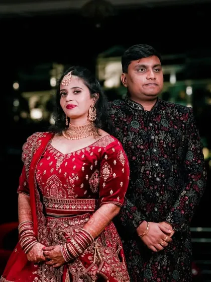 A full-length portrait showcasing the couple's stunning, coordinated reception attire.