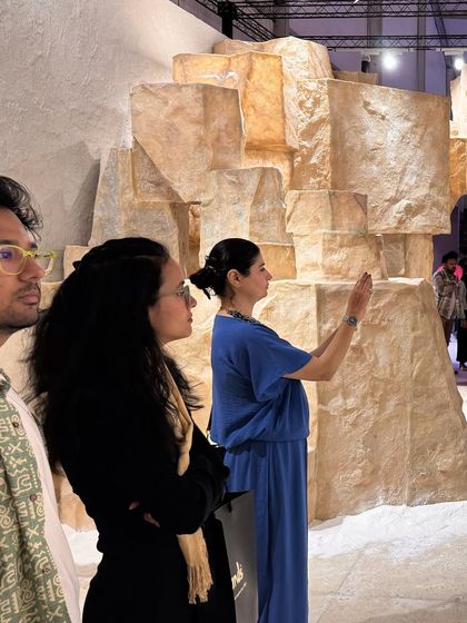 Visitors interacting with the 'Salt' installation. The space is designed to be explored, inviting people to touch and feel the textures of this rediscovered biomaterial, fostering a connection to its ancient story.