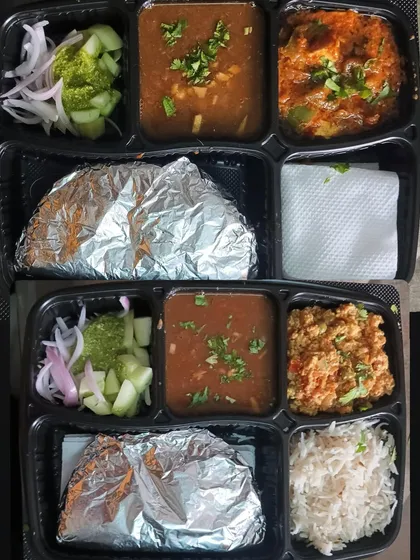 A look at two different thalis prepared in my kitchen. One has Paneer Bhurji and the other has a paneer gravy dish, both served with dal.
