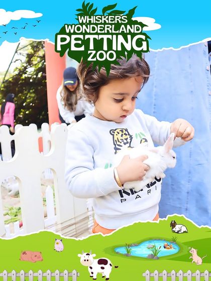 A child gently holds a soft white rabbit at our petting zoo. These hands-on encounters are magical moments that teach children about being gentle and caring towards animals.