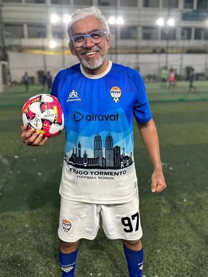 Here is one of our most inspiring players, Nitin, holding a ball on the turf. At over 50, he's a testament to how our program helps maintain fitness and passion for the game.