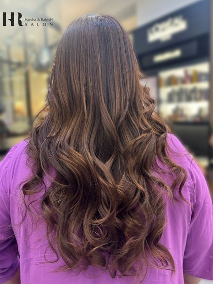 Long, flowing waves show off this perfectly blended balayage with caramel and honey tones.