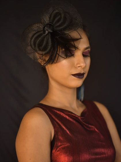 A close-up of the high-fashion makeup with eyes closed, showing the blended smoky eyeshadow.