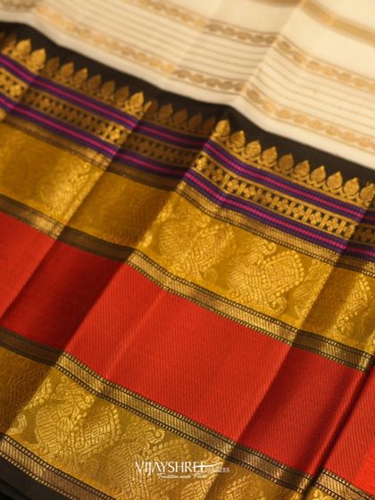 A close-up of the vibrant red, purple, and gold border, showcasing the intricate weaving.