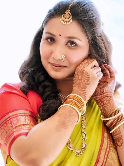 A divine close-up of Sushmita on her engagement day. This shot highlights the traditional maang tikka, nath, and the soft, glowing makeup.