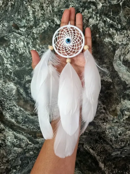 Minimalist vibes, maximum charm. This white evil eye dreamcatcher with soft feathers was customized for a client's car, proving that even small pieces can be beautiful works of art.