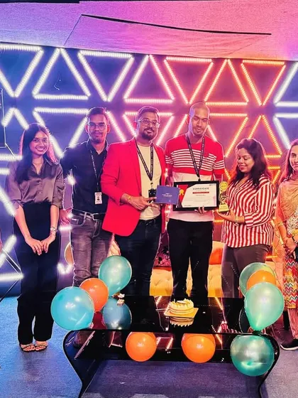 The whole team gathered to celebrate a colleague's two-year anniversary. These moments of appreciation, complete with cake and balloons, are an important part of our company culture.