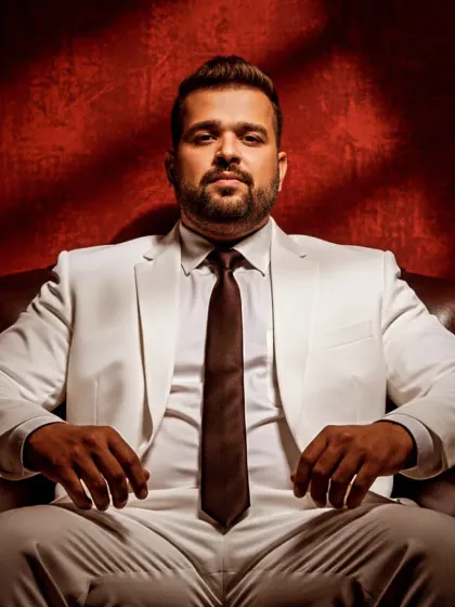 A powerful, seated portrait with dramatic lighting. This image reflects the serious focus and passion I have for music production and the art of DJing.
