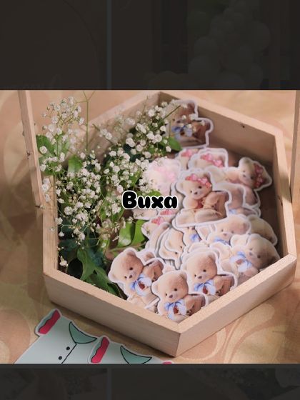 Preparing the pinewood baskets with teddy bear cutouts and baby's breath for a baby shower event.