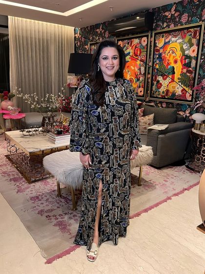 A full-length shot of the client, her unique outfit and elegant makeup creating a memorable look.