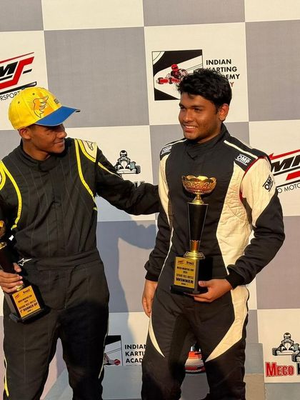 Two teammates celebrating their podium finishes together.