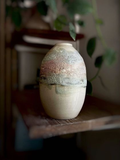 A beautiful vase with a textured, multi-tonal glaze that reminds us of a landscape. We love experimenting with how different glazes interact to create these unique, painterly effects.