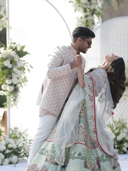 It's the moments of connection that truly matter. We design beautiful backdrops, like this elegant white floral stage, so your first dance as a couple feels as magical and picture-perfect as it should.