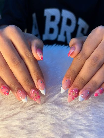 Another angle of these fun and feminine vacation nails. The 3D flowers are carefully sculpted to add dimension without being bulky, ensuring a beautiful and wearable design.