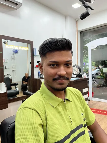 A happy client showing off his new fade haircut. Confidence is the best accessory to any new style.