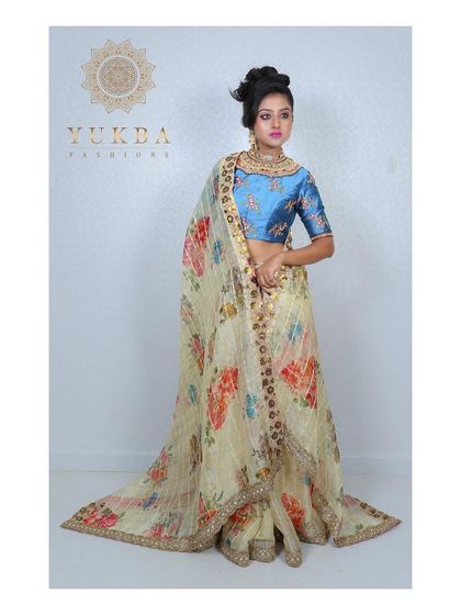 The floral lehenga set styled with a sheer dupatta. The dupatta is edged with a matching border, completing the elegant and whimsical look.