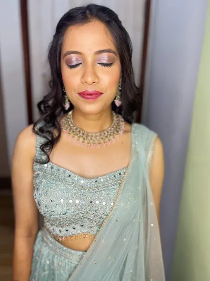 A close-up of the final makeup look. I used soft pink and silver tones on the eyes to complement her beautiful pastel lehenga.