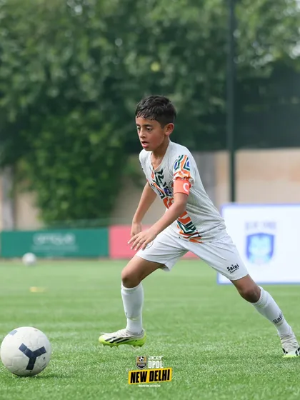 Ready for the pass. This player's stance shows alertness and preparation, demonstrating the tactical awareness we instill in our teams.