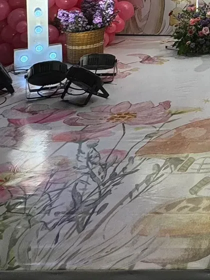 A close up of the custom printed floor vinyl used for the enchanted garden party, featuring a beautiful watercolor design of flowers and mushrooms.