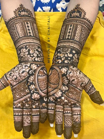 This is a semi-bridal mehendi design, perfect for a bride who wants intricate work that is less extensive than a full-arm design. It features dense patterns on the hands and a detailed cuff on the wrist.