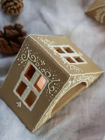 A duplicate of image 132, showing the intricate piping detail on the ceramic house luminary. These personal projects are a big part of my journey as a potter.