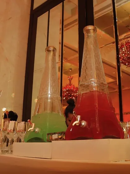 Another view of our popular Eiffel Tower dispensers, filled with colorful cocktails. They are a great way to add a visual statement to any bar setup.