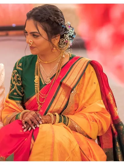 The elegance of a nine-yard saree. Aditi looks graceful during her wedding ceremony, with a modern braided hairstyle complementing her traditional attire.