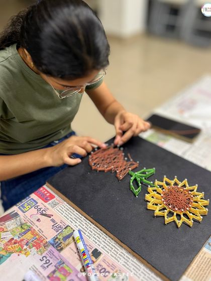 A different angle showing the intricate weaving process for the sunflower's center and stem.