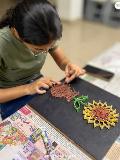 A different angle showing the intricate weaving process for the sunflower's center and stem.