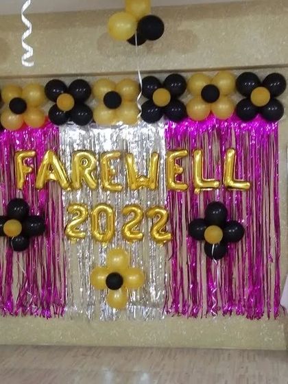 Another angle of the farewell party decoration, showing the black and gold balloon flowers.