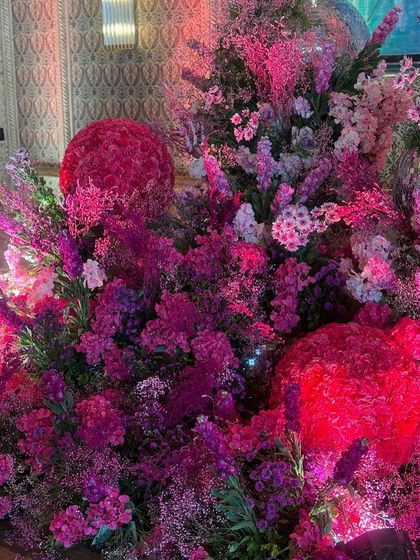 Another detail shot showing the spherical shapes and varied textures within the pink floral installations.