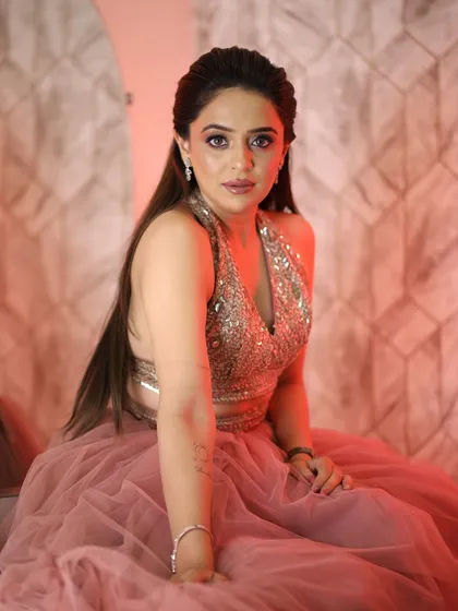 A more dramatic pose with red lighting. The makeup holds up beautifully, proving that soft glam can also be bold.