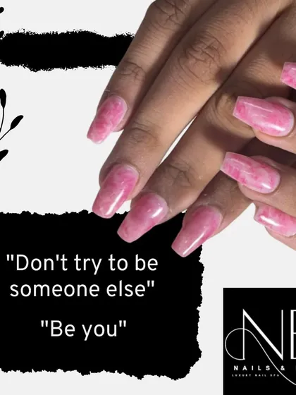 "Don't try to be someone else. Be you." This pink marble design on coffin-shaped nails is for embracing your unique style.