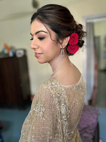 A side profile showing off the elegant hairstyle and the flawless makeup. This look is pure class.