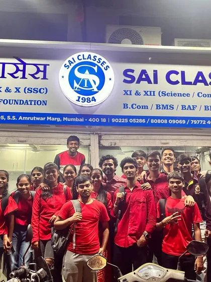 A group of students posing proudly in their red outfits outside our classes during Navratri 2023.