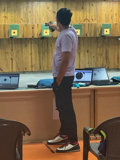 A shooter in deep concentration, aiming at the electronic target. Our range is equipped with modern SIUS electronic targets for precise scoring and analysis.